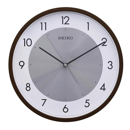 Seiko wall clock with brown frame and white face on a white background
