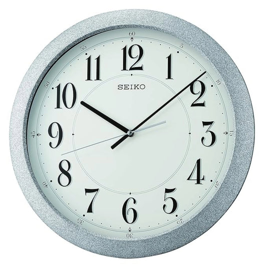 Seiko wall clock with silver glittery frame on a white background