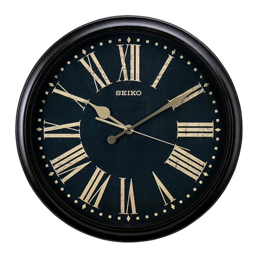 Black Seiko wall clock with gold Roman numerals on a white background