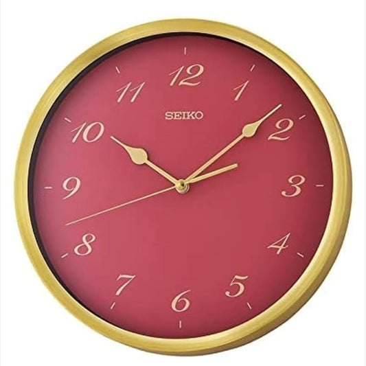 Seiko wall clock with red face and gold frame on a white background