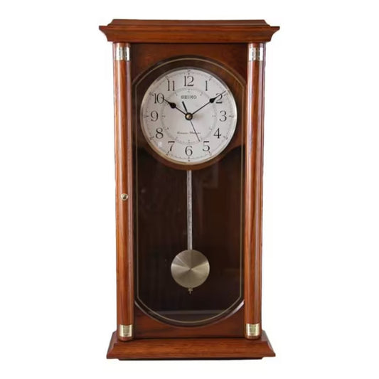 Wooden wall clock with pendulum on a white background