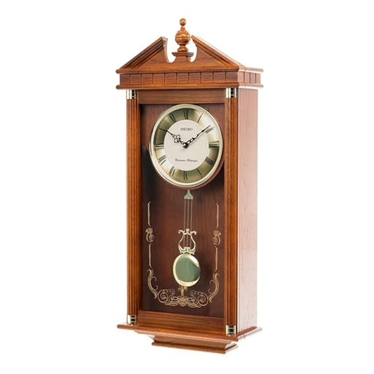 Wooden wall clock with pendulum on a white background
