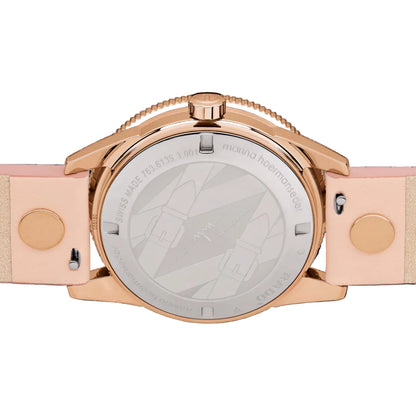 Rose gold watch with a pink strap on a black background