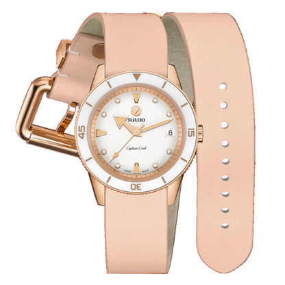 Rose gold watch with a white face on a black background
