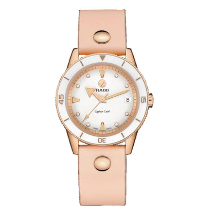 Rose gold watch with white dial on a black background