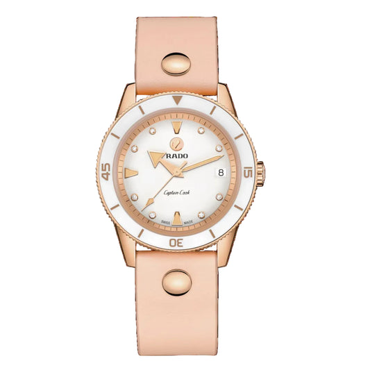 Rose gold watch with white dial on a black background