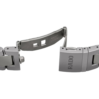 Metallic watch strap with Rado branding on a black background