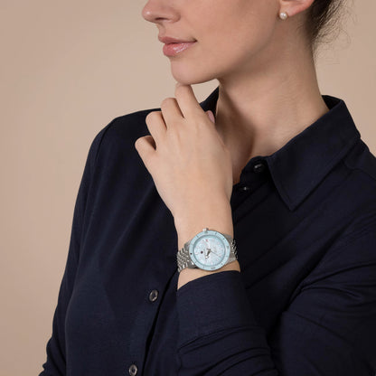 Woman wearing a watch with a neutral background