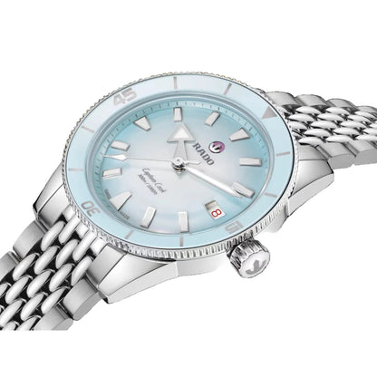 Silver watch with a light blue face on a black background