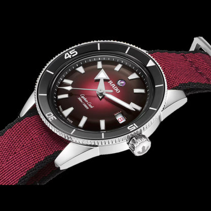 Watch with a red strap and dark face on a black background