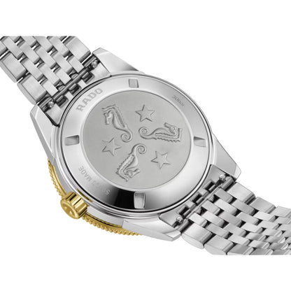 Silver watch with a detailed back cover on a white background