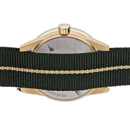 Watch with gold case and green strap on a black background