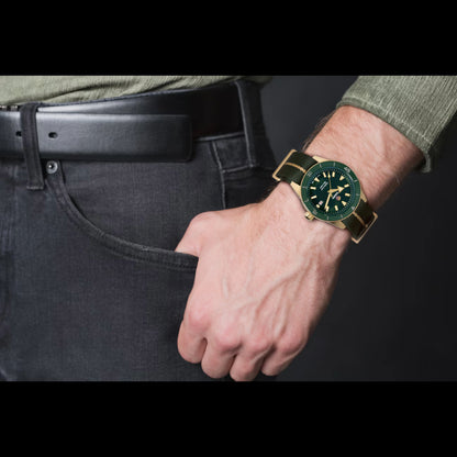 Hand wearing a green watch with a dark background