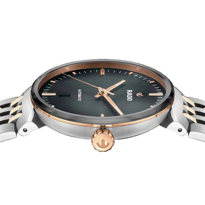 Watch with black dial, rose gold accents, and silver metal strap on a black background