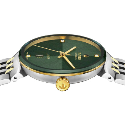 Watch with green dial and gold accents on a black background
