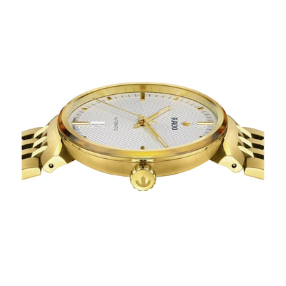 Gold watch with a white face on a light gray background