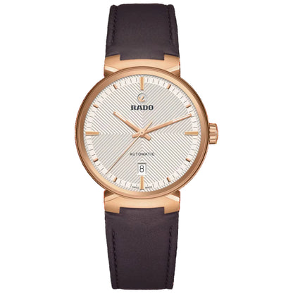 Rado watch with rose gold case and dark blue leather strap on a white background