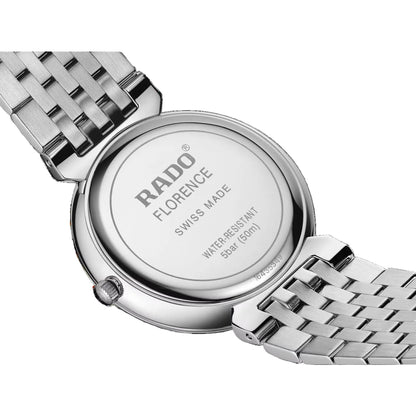 Close-up of a Rado watch with a metallic band on a black background