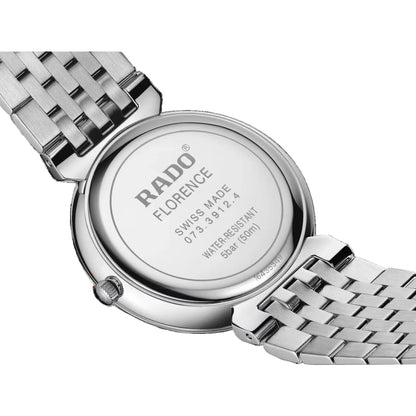 Close-up of a Rado watch with a metallic band on a black background