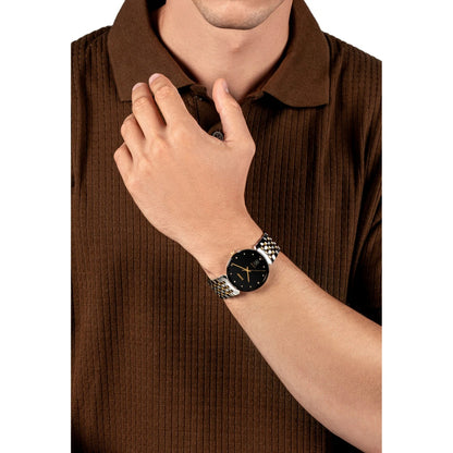 Person wearing a watch with a brown shirt on a white background