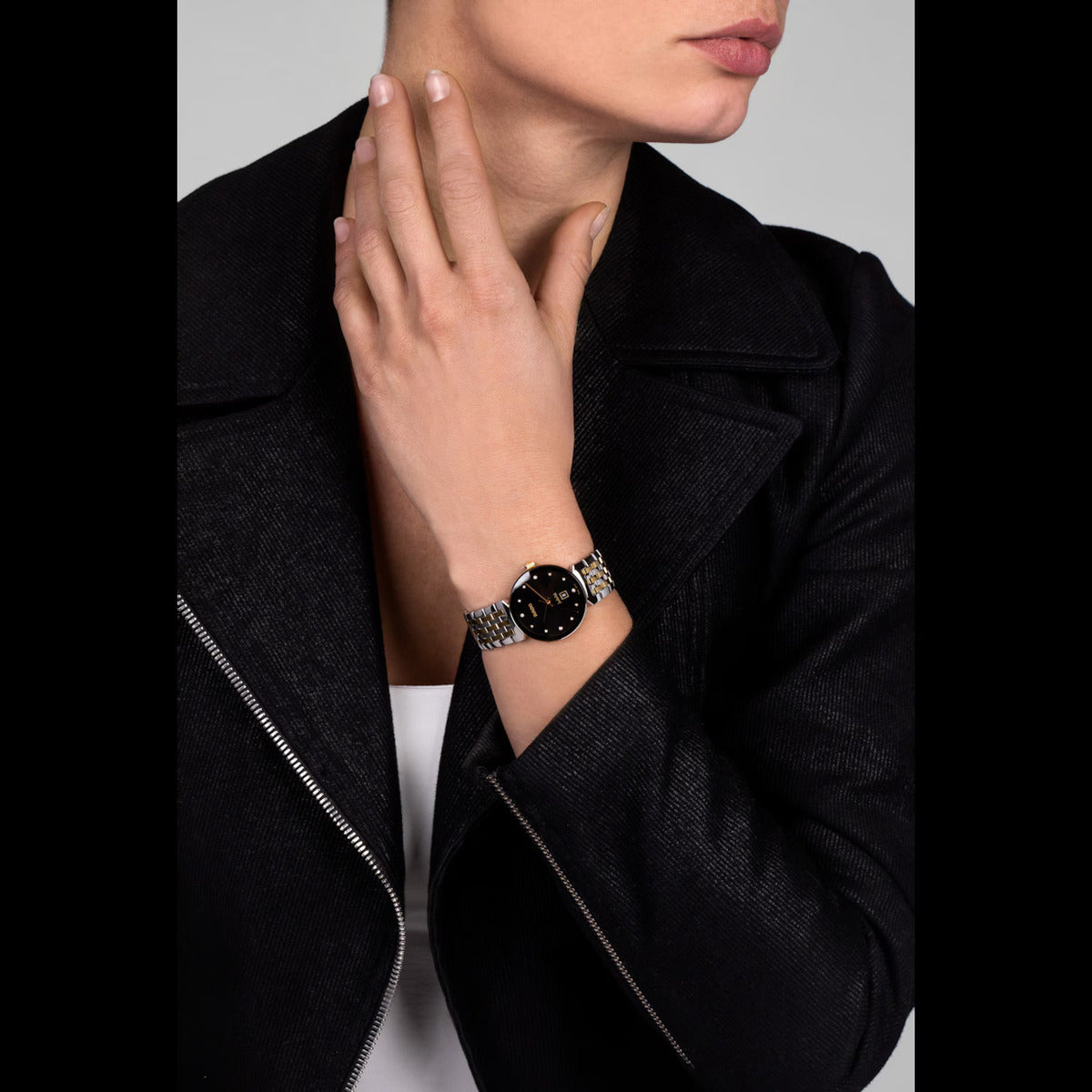 Person wearing a black watch on a gray background