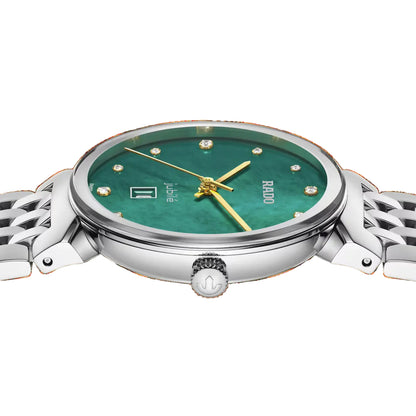 Watch with green face and silver case on a white background