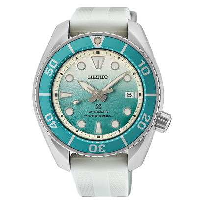 Seiko watch with turquoise dial and white strap on a white background