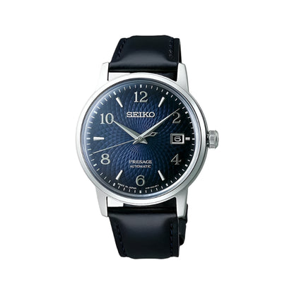 A Seiko Presage Cocktail Time men's watch with a blue dial and a black leather band.