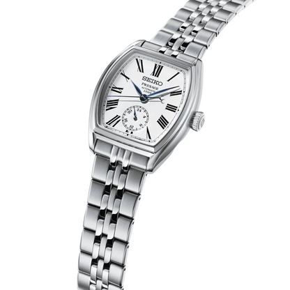 Silver Seiko watch with a white face on a light gray background