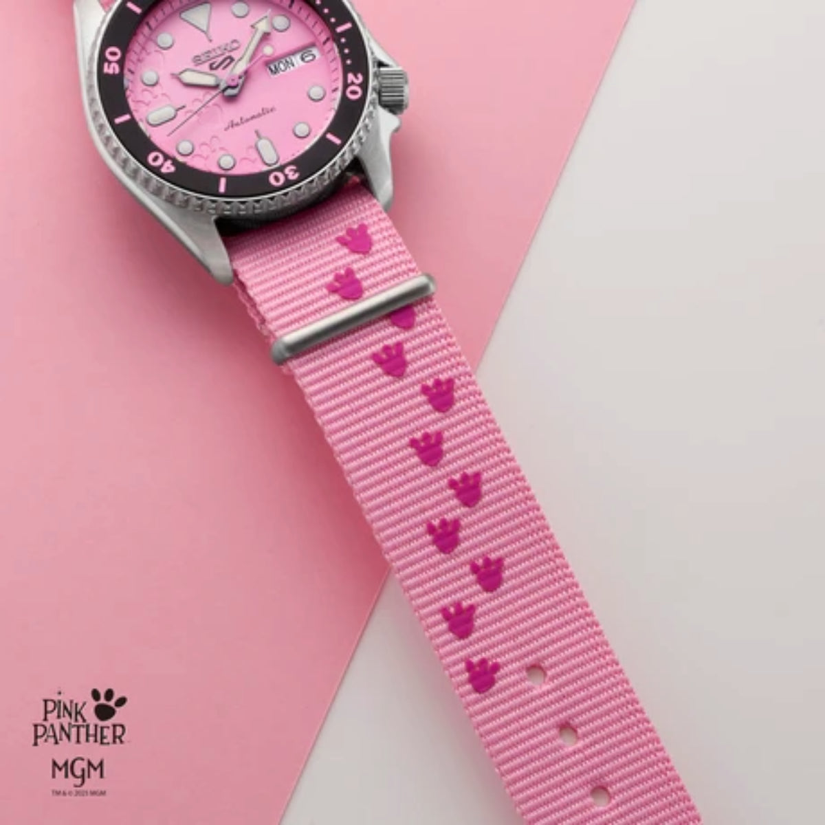 Watch with pink strap featuring heart patterns on a pink background, branded 'Pink Panther MGM'.