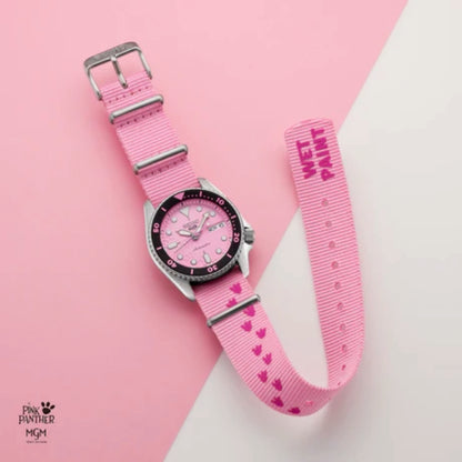 Pink watch with heart pattern strap on a pink background