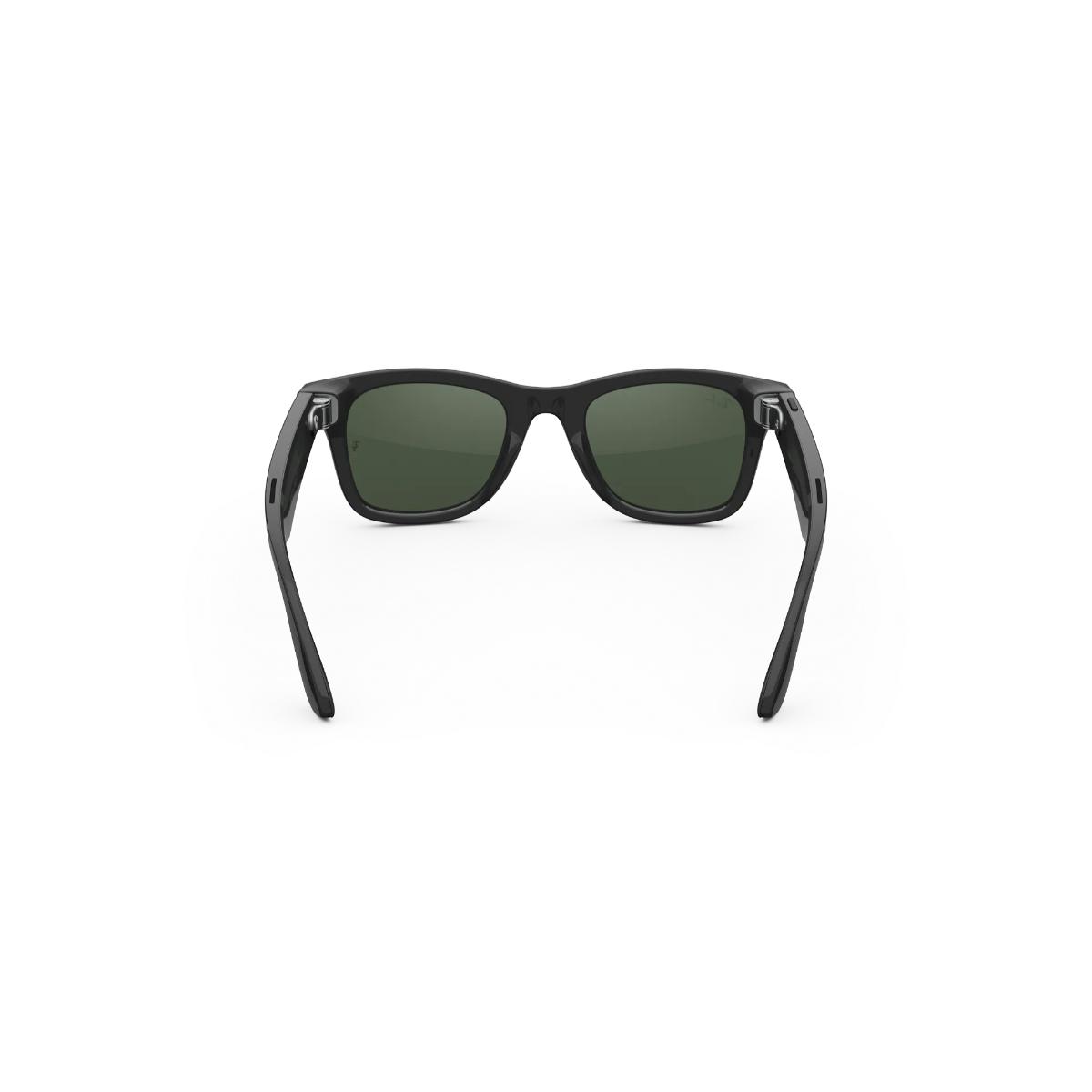 Black sunglasses with green lenses on a white background