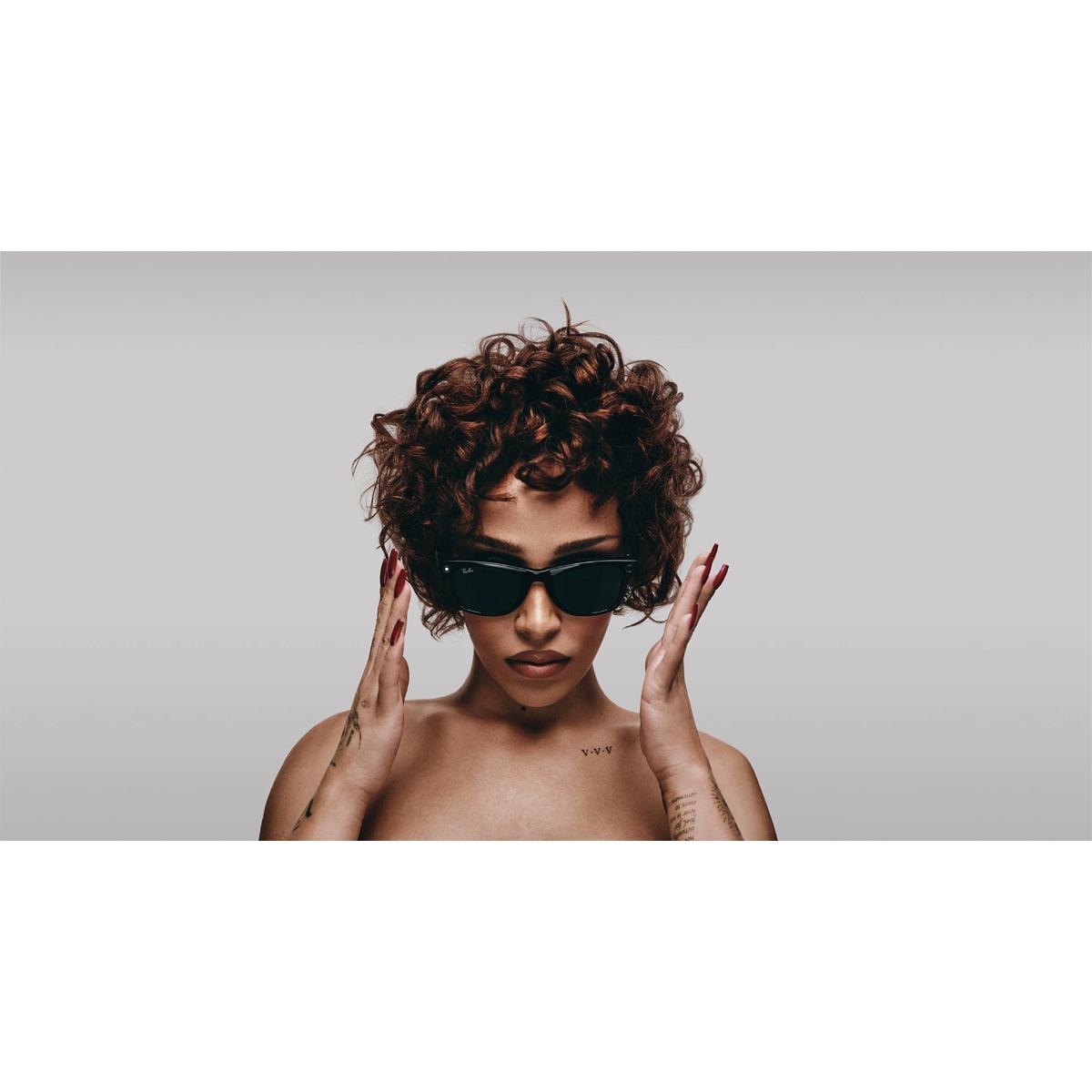 Woman wearing sunglasses with a neutral background