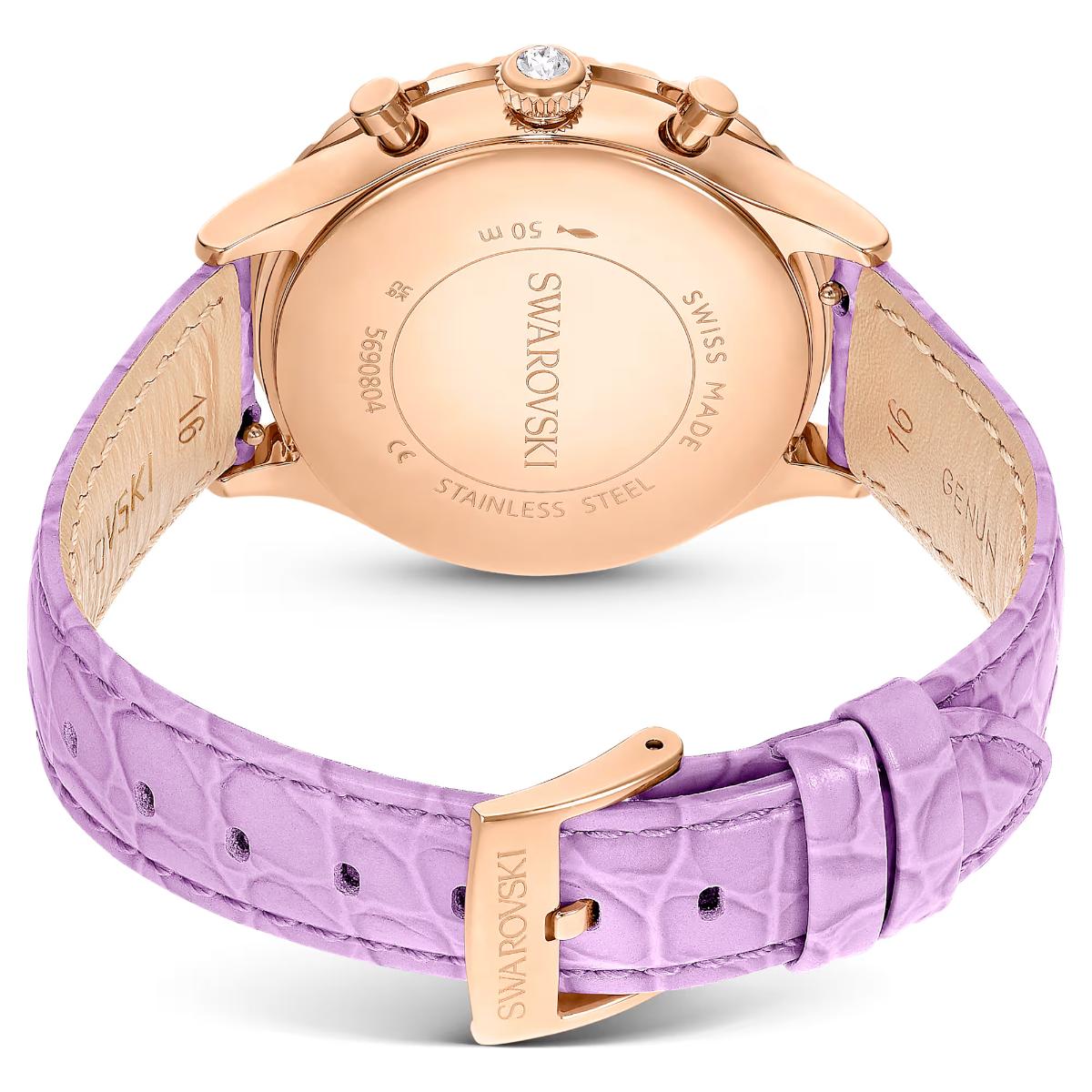 Swarovski watch with rose gold case and purple strap on a white background