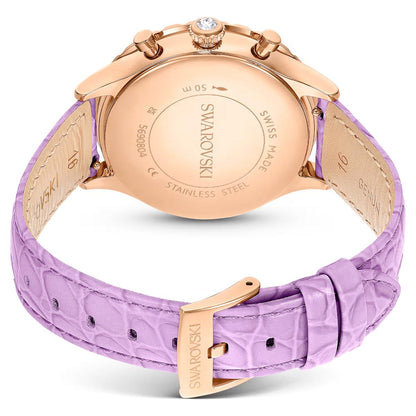 Swarovski watch with rose gold case and purple strap on a white background