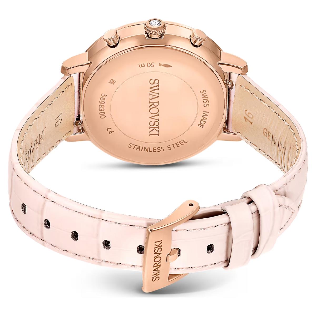 Rose gold Swarovski watch with pink leather strap on a white background