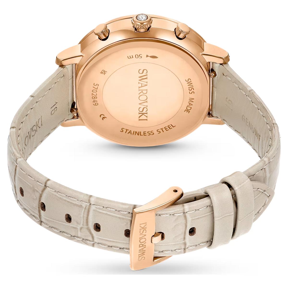 Swarovski watch with rose gold case and beige leather strap on a white background