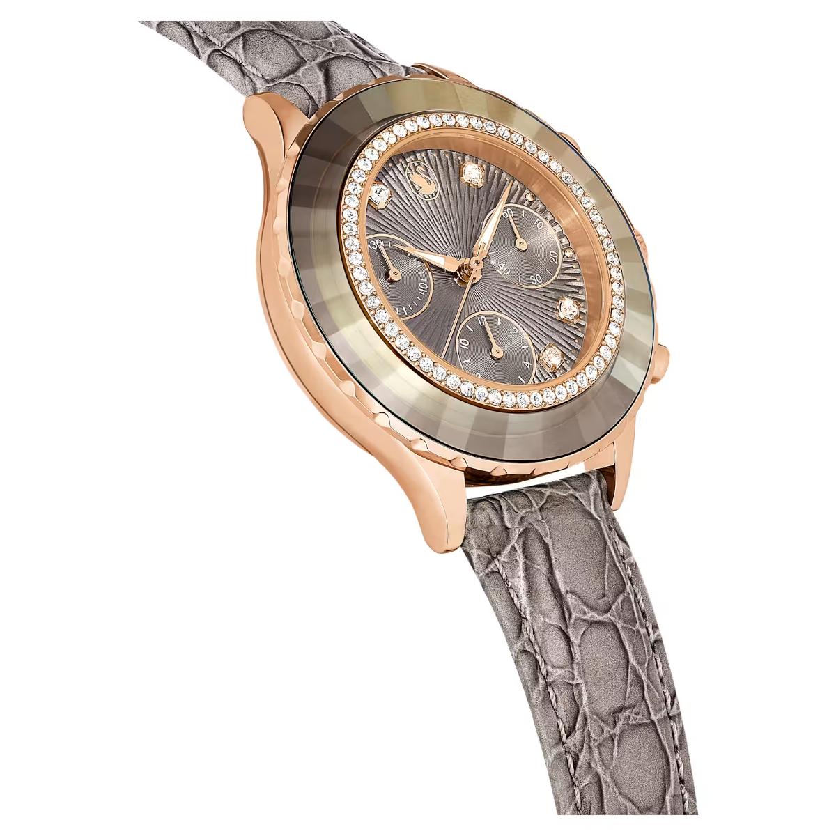 Luxury watch with rose gold case and gray strap on white background