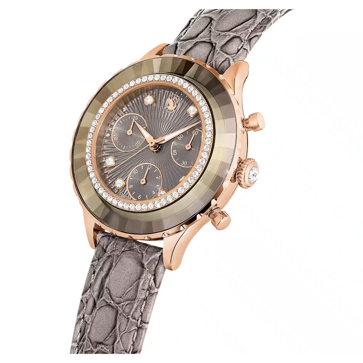Luxury watch with rose gold case, gray strap, and diamond-studded face on a white background