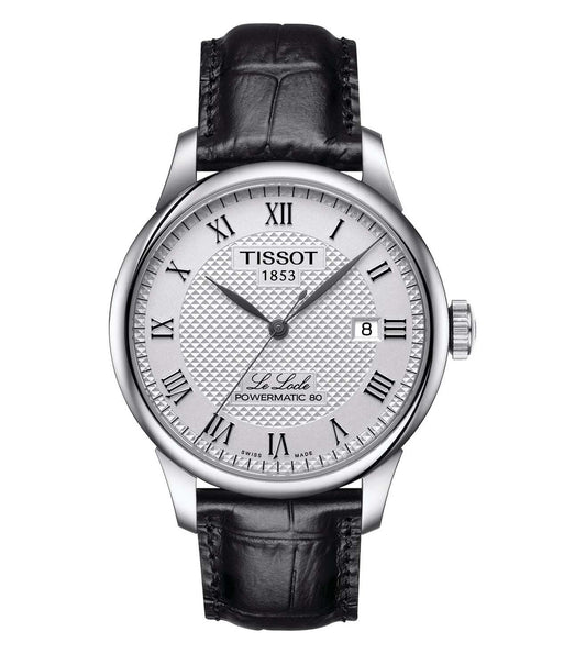 A TISSOT men's watch with a round silver dial, black leather strap, and a silver case. Features include a date display and a traditional analog design.