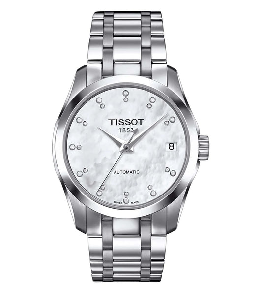 A TISSOT Couturier Automatic Lady watch with a round dial, stainless steel strap, and silver case.