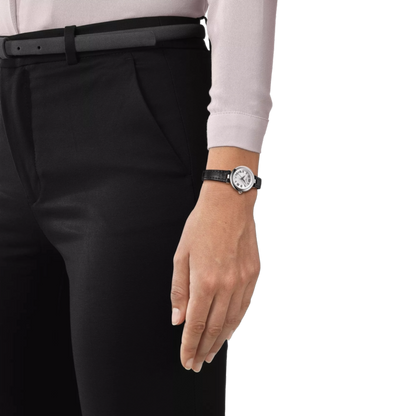 Person wearing a black watch on a white background