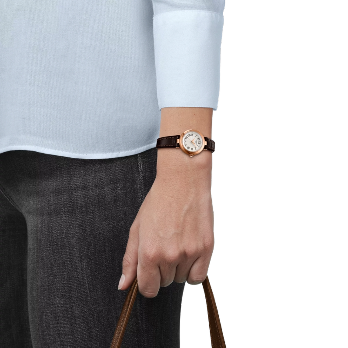 Person wearing a watch with a plain background