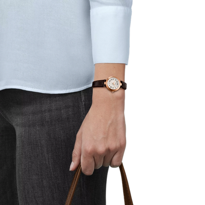 Person wearing a watch with a plain background