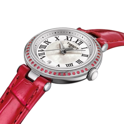 Tissot watch with red strap and gemstone accents on a white background