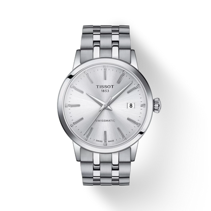 Silver Tissot watch with a white face on a light gray background