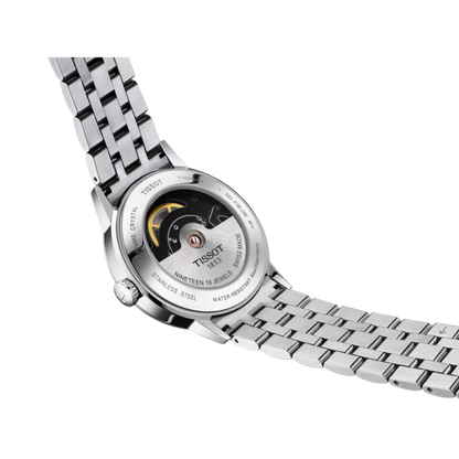 Close-up of a Tissot watch with a metal bracelet on a white background