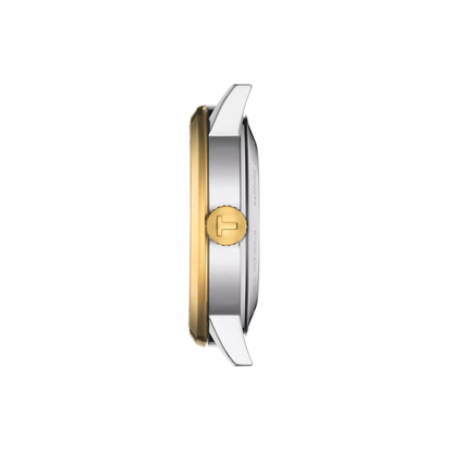 Close-up of a watch with gold and silver band on a white background