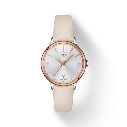 Tissot watch with beige strap and rose gold case on white background