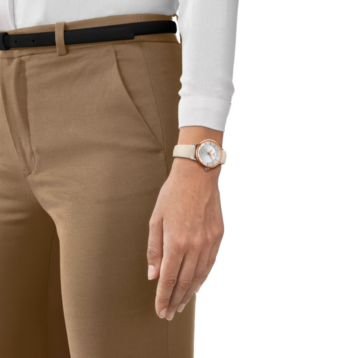 Person wearing beige pants and a white shirt with a watch on a plain background